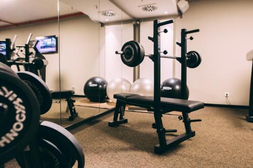 a gym with a row of dumbbells and mirrors at Me and All Hotel Dusseldorf, by Hyatt in Düsseldorf