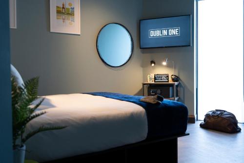 a bedroom with a bed and a round mirror at Dublin One in Dublin