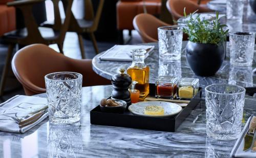 a table with glasses and a tray of food on it at Crowne Plaza Copenhagen Towers by IHG in Copenhagen