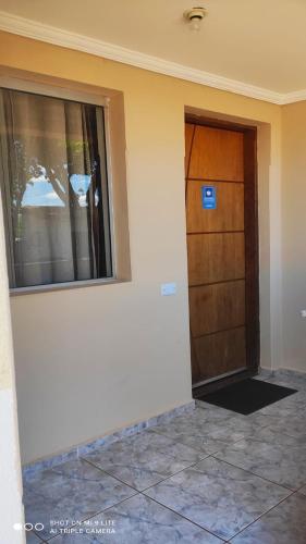 a room with a door and a window on a building at Pousada Recanto das Maritacas in Brotas