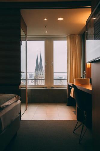 a hotel room with a view of a building at Me and All Hotel Dusseldorf, by Hyatt in Düsseldorf