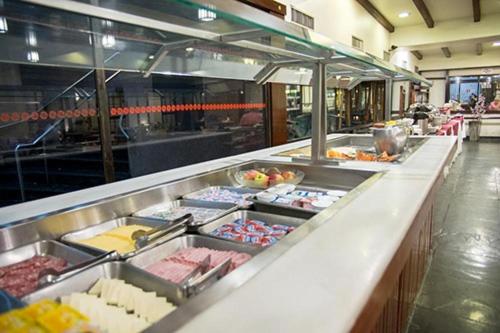 a buffet of food is displayed in a restaurant at Nikkey Palace Hotel in Sao Paulo