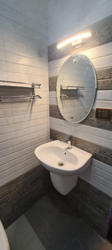 a bathroom with a sink and a mirror at Richard Inn Residency in Calangute
