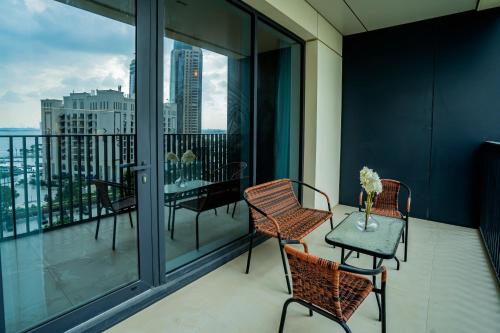 a balcony with chairs and a table with a view at Magnolia- Dubai Creek Harbour Condo Apartment ApartHotel UAE in Dubai