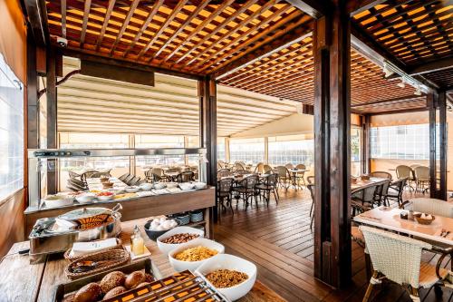 a restaurant with food on a table with tables and chairs at Nof Tavor Hotel in Mizra‘