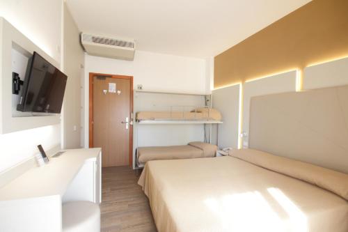 Postel nebo postele na pokoji v ubytování Hotel Toledo
