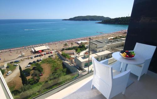 a balcony with a view of a beach and the ocean at Shine residence in Budva