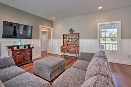 a living room with two couches and a tv at Morrisonville Manor with Fire Pit and Hot Tub! in Britain