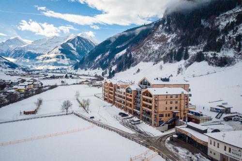a resort in the mountains with snow on the ground at Carpe Solem Rauris by ALPS RESORTS in Rauris