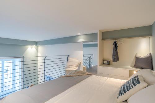 a bedroom with a large white bed and a window at Suite Tigli - by MyHomeInComo in Como