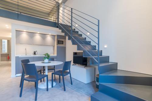 a kitchen and dining room with a blue staircase at Suite Tigli - by MyHomeInComo in Como
