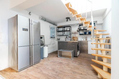 a kitchen with a staircase and a refrigerator in a room at pestahome in Hannover