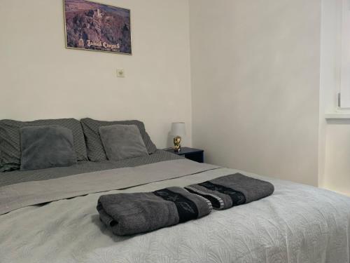 a bedroom with a bed with two towels on it at Apartament pod Zamkiem Chojnik in Jelenia Góra