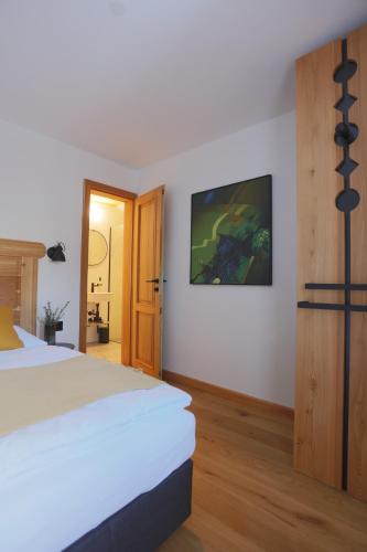 a hotel room with a bed and a door at Schneiderhaus in Mauterndorf