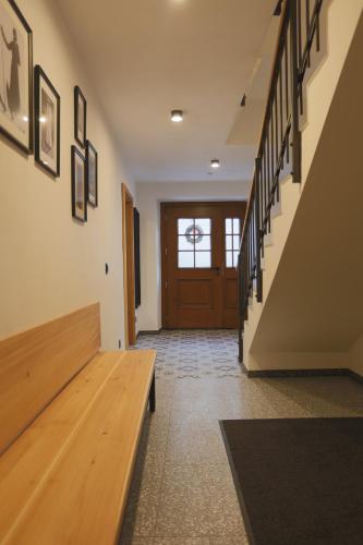 a hallway with a wooden bench in front of a door at Schneiderhaus in Mauterndorf