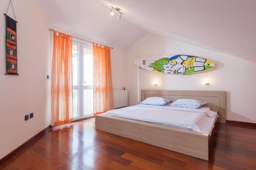 um quarto com uma cama e uma grande janela em Apartments Tino em Makarska
