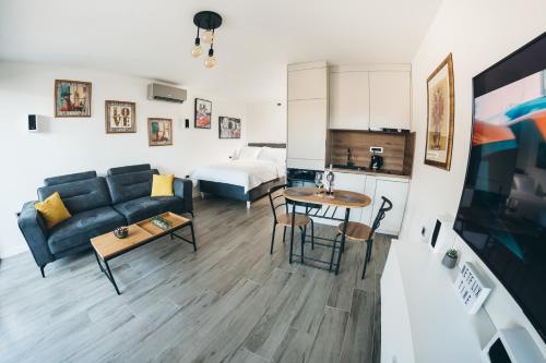 a living room with a couch and a table at HelloSky Apartment in Mostar