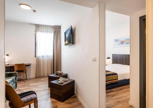a hotel room with a bedroom and a bed at Nof Tavor Hotel in Mizra‘