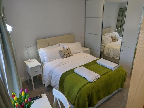 a small bedroom with a bed and a mirror at Darracott Farm Cottage in Welcombe