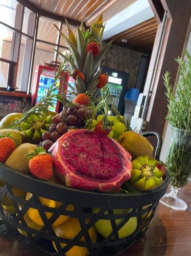 a bowl of fruit sitting on a table at WINNER BEACH HOTEL in Juréia