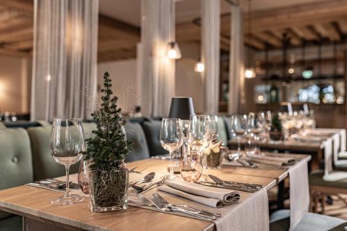 a long table with wine glasses and a centerpiece at Hotel Pirchnerhof in Reith im Alpbachtal