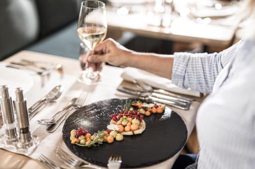a person sitting at a table with a plate of food at Hotel Pirchnerhof in Reith im Alpbachtal