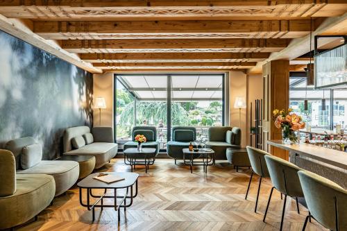 a lobby of a hotel with couches and tables at Hotel Pirchnerhof in Reith im Alpbachtal