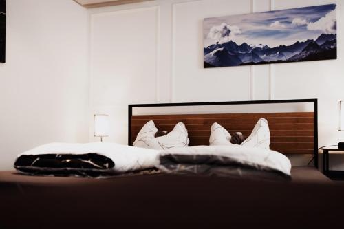 a bedroom with a bed with white sheets and pillows at Unterkunft KemptenCityHost in Kempten