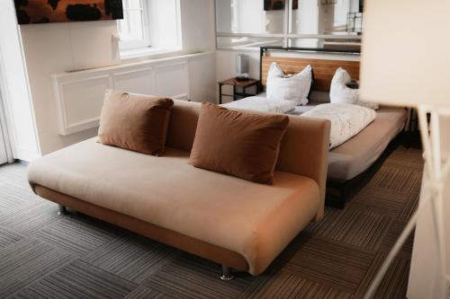 a living room with a couch and two pillows at Unterkunft KemptenCityHost in Kempten