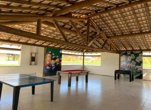 a room with two ping pong tables in it at Apto Térreo - Condomínio Vila das Águas in Estância