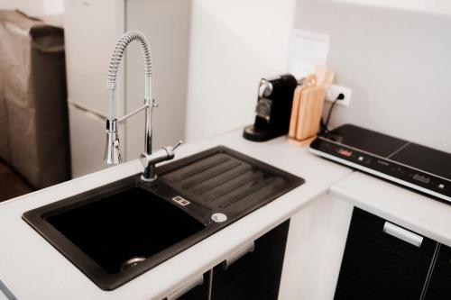 a kitchen counter with a sink and a microwave at Unterkunft KemptenCityHost in Kempten