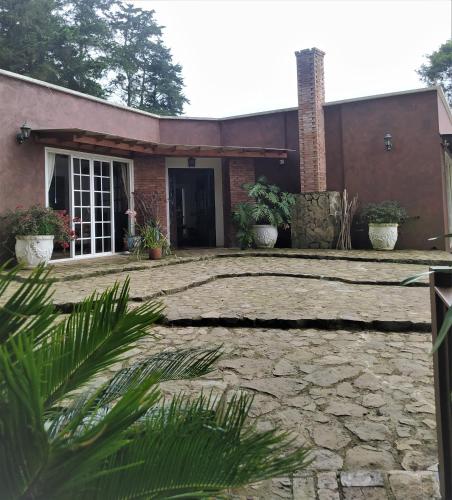 a house with a stone driveway in front of it at Condominio Hacienda Shangrila in San Francisco