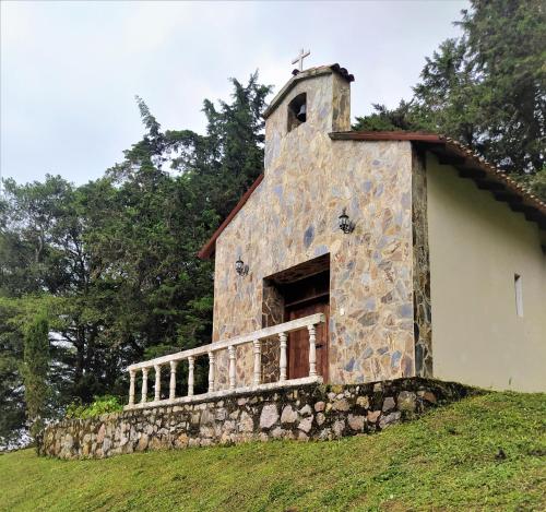 an old stone church on a grassy hill at Condominio Hacienda Shangrila in San Francisco