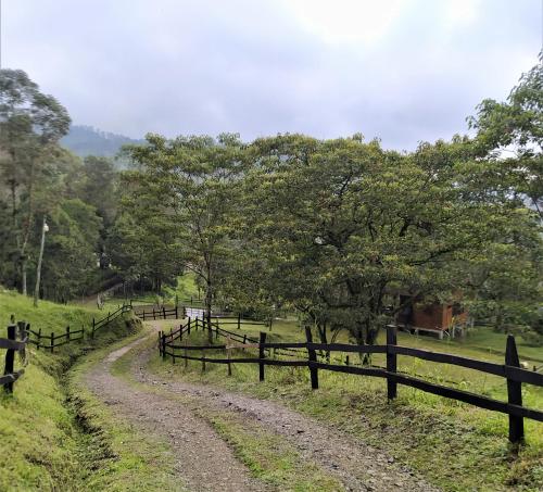 a dirt road in a field next to a fence at Condominio Hacienda Shangrila in San Francisco