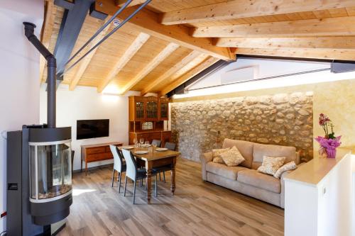 a living room with a fireplace and a dining room at Residence Rustico in Garda