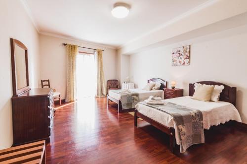 a large room with two beds and a couch at Funchal Downtown by ALMA Holiday Rentals in Funchal