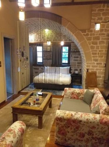 a living room with a couch and a coffee table at Soul boutique hotel in Monodendri