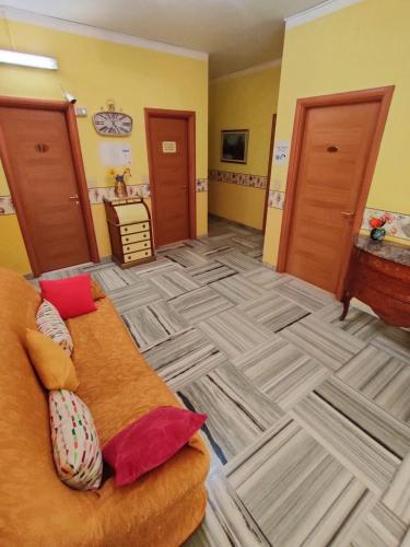 a living room with a couch in the middle of a room at Hotel Serenella in Turin