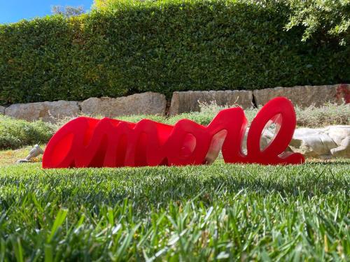 a red sign on the grass in the grass at Gran Paradiso Hotel Spa in San Giovanni Rotondo