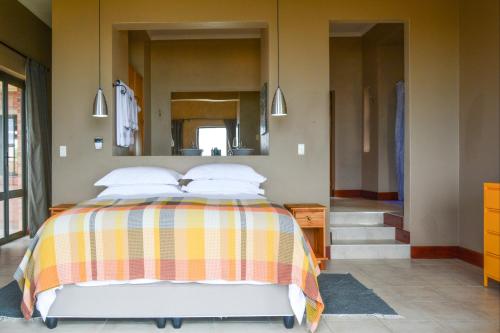 a bedroom with a bed and a large mirror at 4 Zwaan in Jeffreys Bay