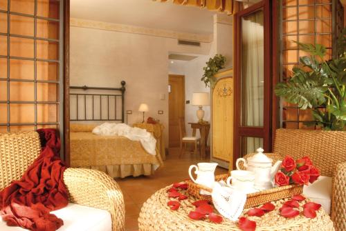 a living room with a bed and a mirror at Hotel La Locanda Dei Ciocca in Grottaferrata