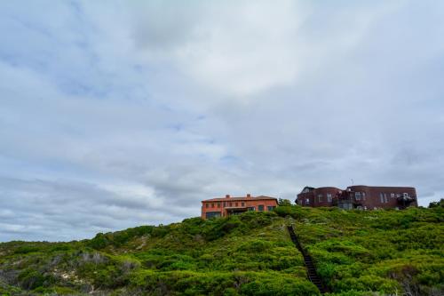 a house sitting on top of a hill at 4 Zwaan in Jeffreys Bay