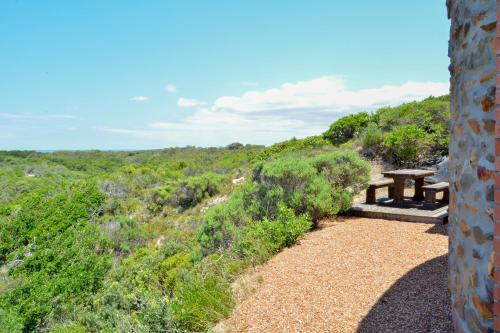 a picnic table sitting on top of a hill at 4 Zwaan in Jeffreys Bay