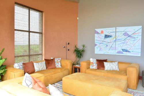 a living room with couches and a large window at 4 Zwaan in Jeffreys Bay