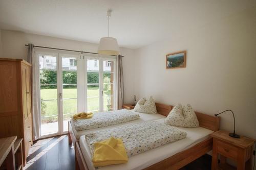 a bedroom with two beds and a window at CityChalet in Interlaken