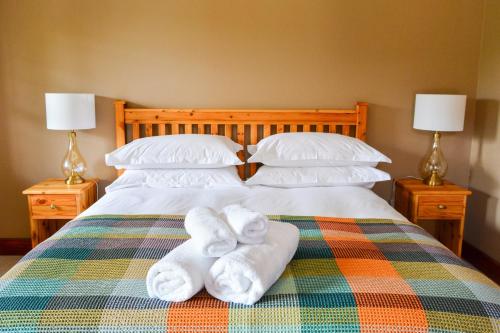 a bedroom with a bed with towels on it at 4 Zwaan in Jeffreys Bay