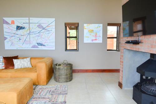 a living room with a couch and a fireplace at 4 Zwaan in Jeffreys Bay