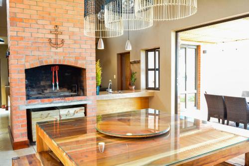 a living room with a table and a fireplace at 4 Zwaan in Jeffreys Bay