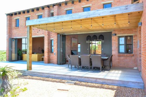 an outdoor patio with a table and chairs at 4 Zwaan in Jeffreys Bay