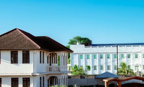 a view of a white building and a building at SULKHAN SERVICED APARTMENT in Chukwani